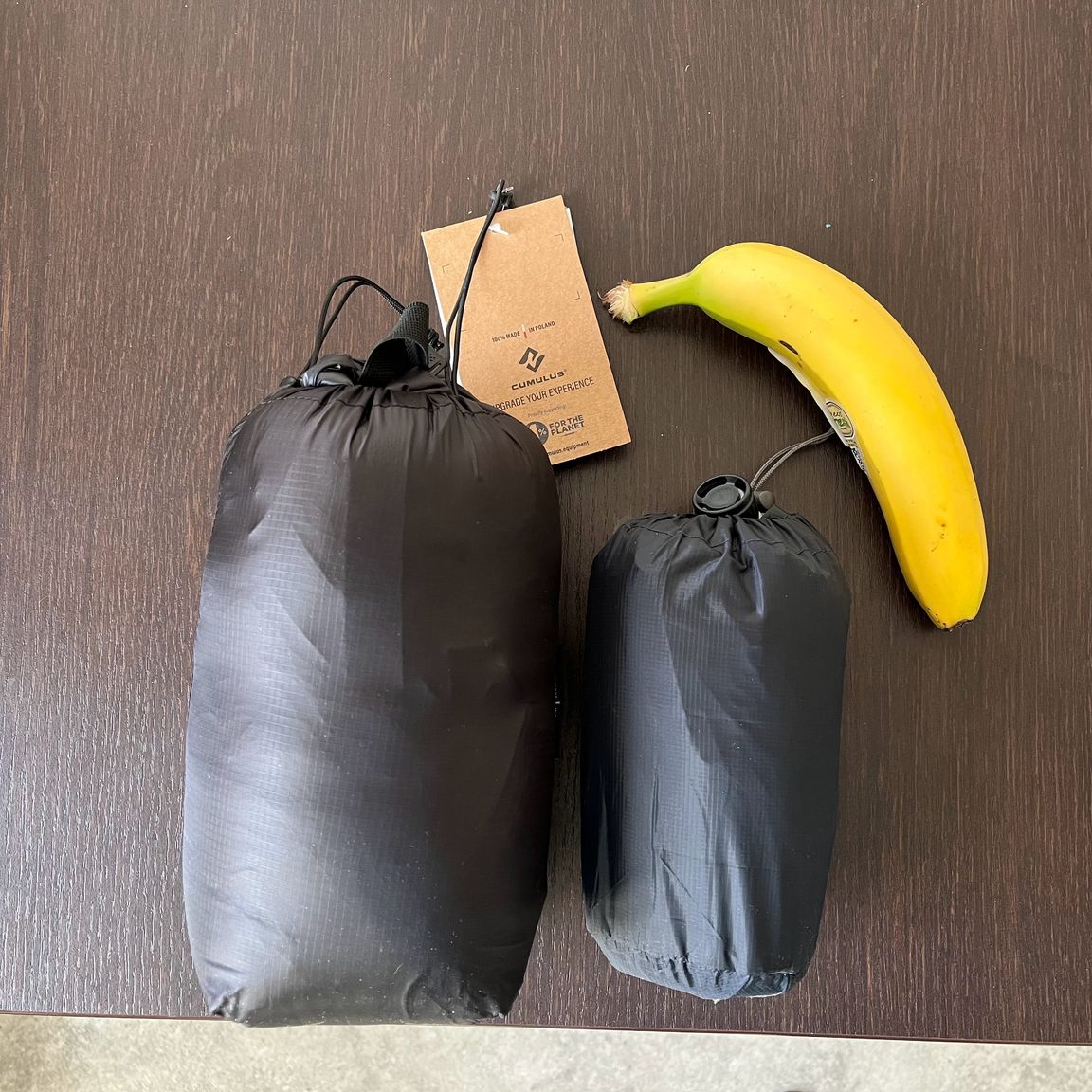 The Cumulus Quilt 150 and the Therma-a-Rest UberLite on a table, with a banana for scale